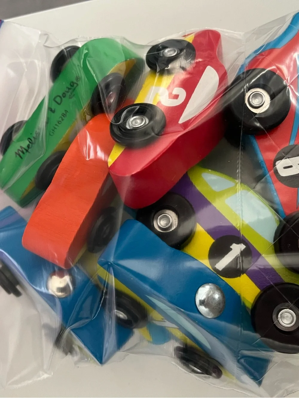 8 wooden racing cars.   Cars Number 1-4 are Melissa & Doug.